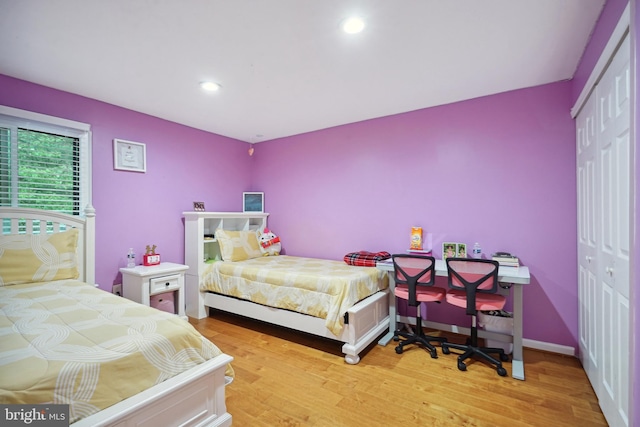 bedroom featuring light hardwood / wood-style floors and a closet