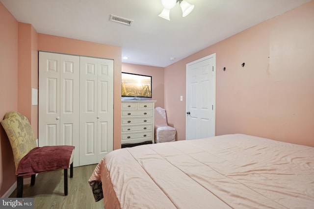 bedroom with ceiling fan and light hardwood / wood-style floors