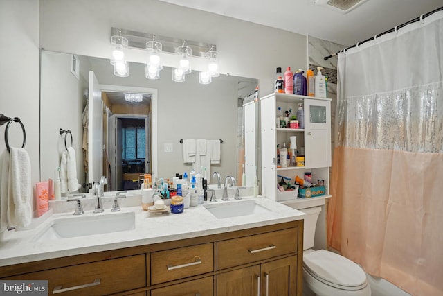 full bathroom featuring shower / bath combo, vanity, and toilet