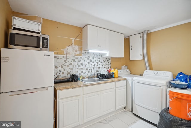 laundry room featuring washing machine and clothes dryer and sink