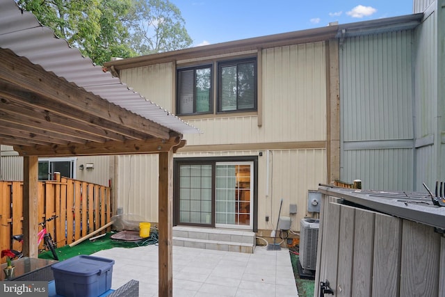 back of property with cooling unit and a patio