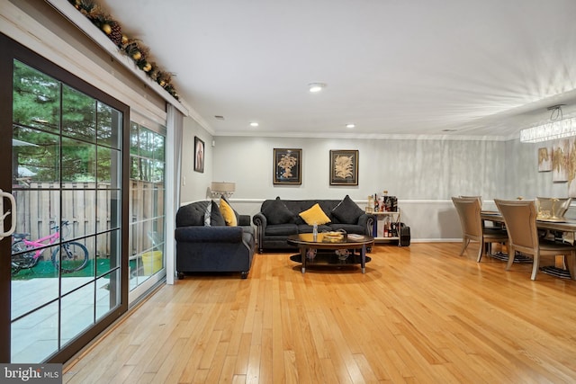 living room featuring light hardwood / wood-style flooring and ornamental molding