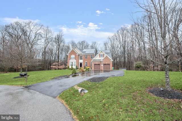 view of front facade featuring a front yard, solar panels, and a garage