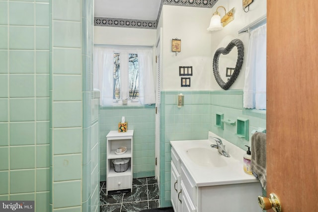 bathroom featuring vanity and tile walls