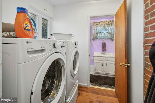 laundry room with washer and dryer and dark hardwood / wood-style floors