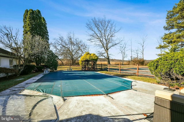 view of pool featuring a rural view and a patio