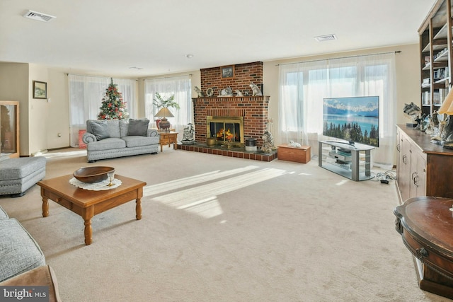 carpeted living room with a brick fireplace and plenty of natural light