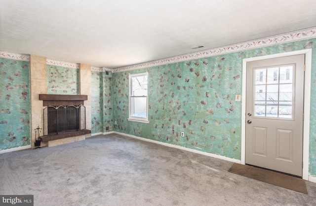 unfurnished living room featuring carpet and a fireplace