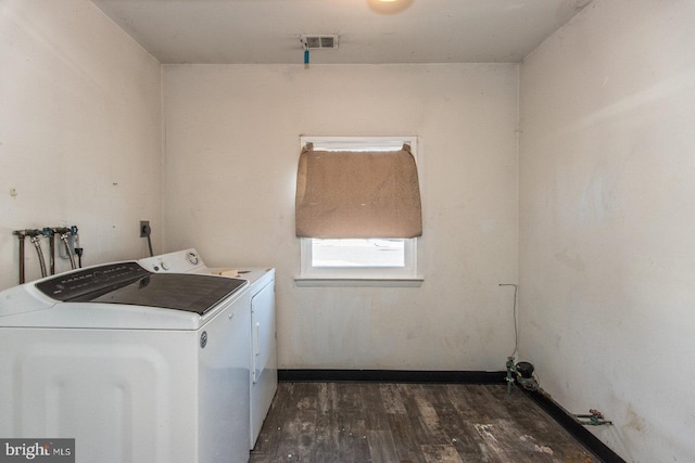 washroom featuring separate washer and dryer and dark hardwood / wood-style floors