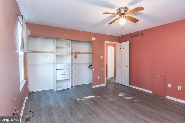 unfurnished bedroom featuring ceiling fan, a closet, and dark hardwood / wood-style floors