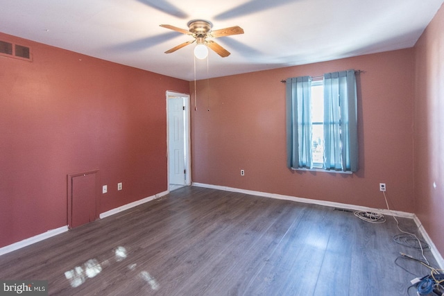 empty room with dark hardwood / wood-style flooring and ceiling fan