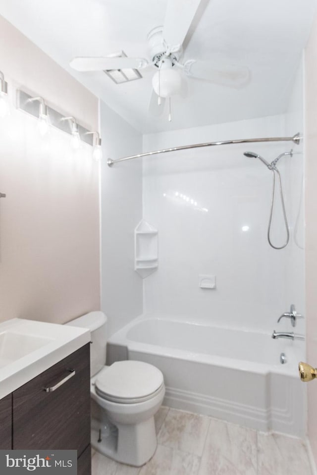 full bathroom with ceiling fan, vanity, bathtub / shower combination, and toilet