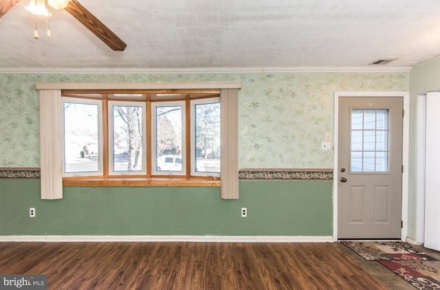 entrance foyer featuring dark hardwood / wood-style floors, ceiling fan, crown molding, and a textured ceiling