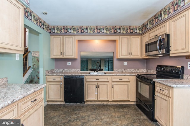 kitchen featuring black appliances, light brown cabinets, light stone counters, and sink