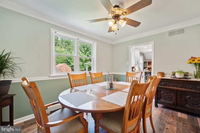 dining space featuring a baseboard heating unit, dark hardwood / wood-style floors, ceiling fan, and crown molding