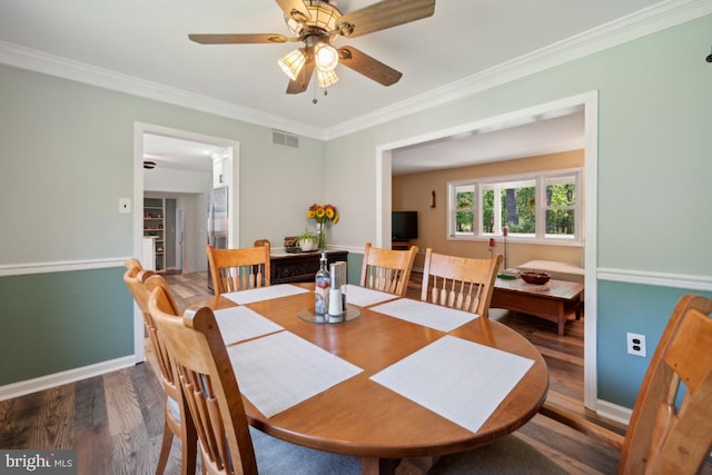 dining space featuring ceiling fan, ornamental molding, and hardwood / wood-style flooring