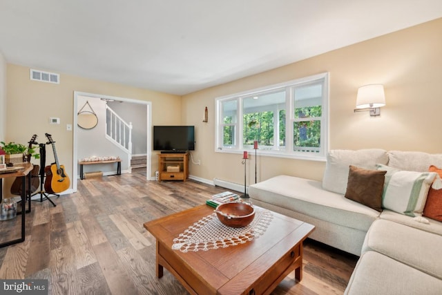 living room with a baseboard radiator and hardwood / wood-style flooring