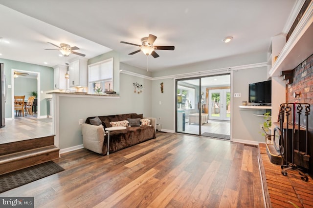 living room featuring ceiling fan, french doors, and wood-type flooring