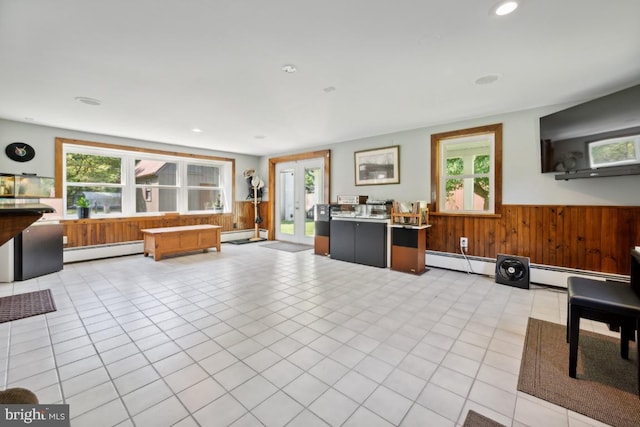 tiled living room with baseboard heating and french doors