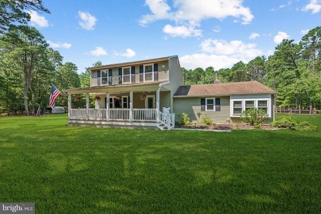 back of house with a lawn and covered porch