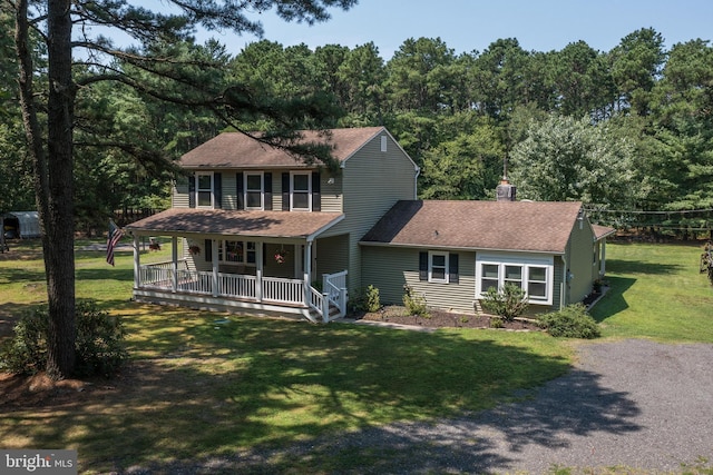 view of front of house featuring covered porch and a front lawn