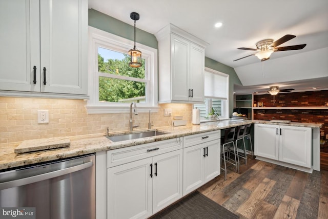 kitchen featuring dishwasher, a healthy amount of sunlight, white cabinetry, and sink