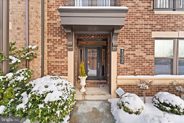 view of snow covered property entrance