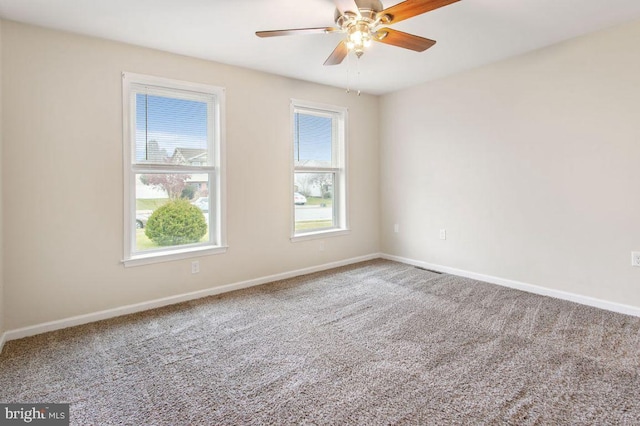 spare room with carpet and ceiling fan