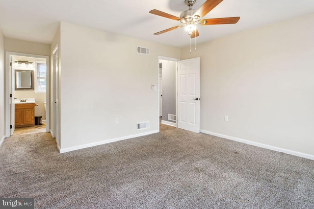 unfurnished bedroom featuring carpet floors, ensuite bathroom, and ceiling fan