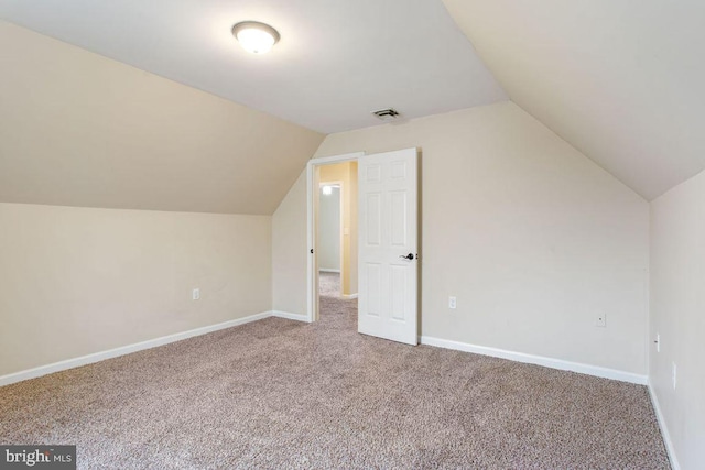 additional living space with carpet and lofted ceiling