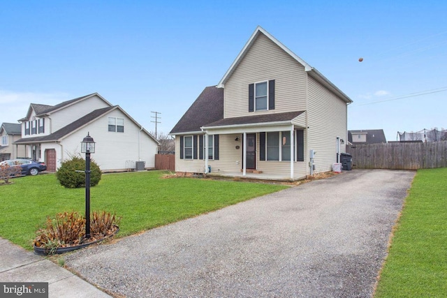 view of front of property featuring covered porch, central AC unit, and a front lawn