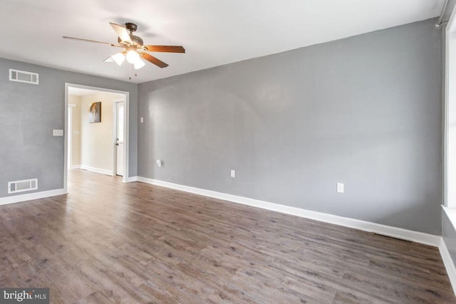 spare room featuring ceiling fan and dark wood-type flooring