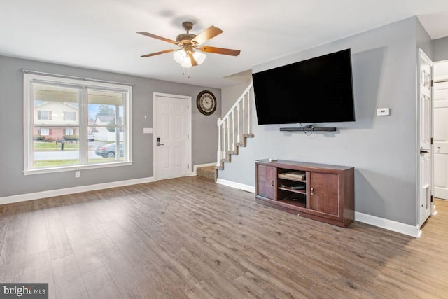 unfurnished living room with ceiling fan and light hardwood / wood-style flooring