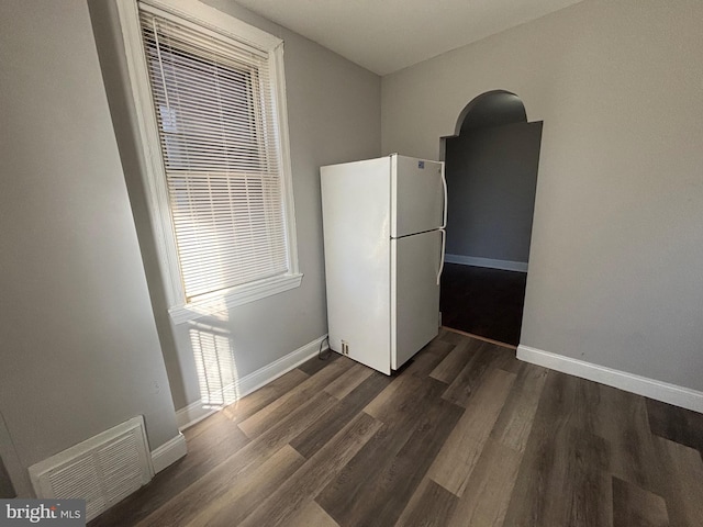 unfurnished dining area with dark hardwood / wood-style flooring