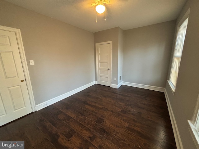 spare room with dark wood-type flooring