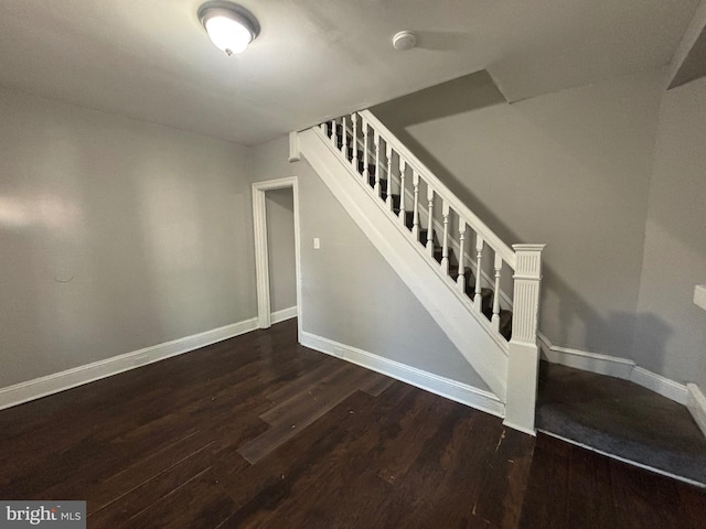 stairs featuring hardwood / wood-style floors