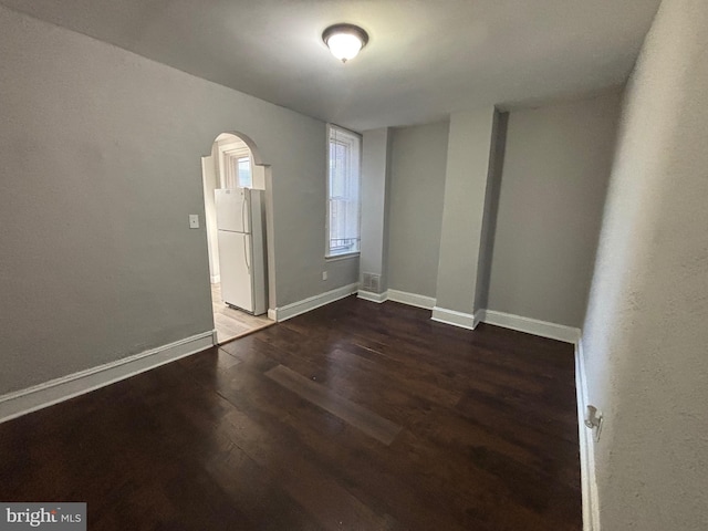 unfurnished room featuring dark hardwood / wood-style floors