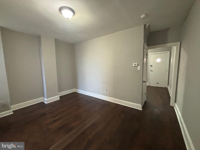 spare room with dark hardwood / wood-style flooring