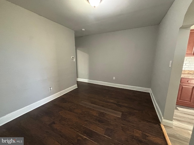 spare room with wood-type flooring