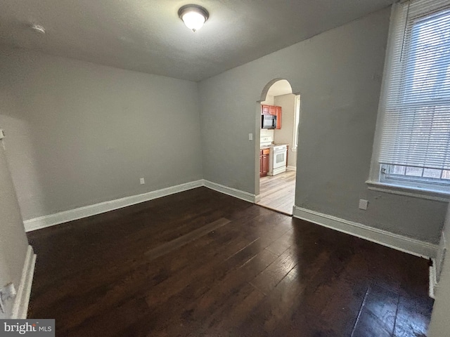 empty room with dark hardwood / wood-style floors