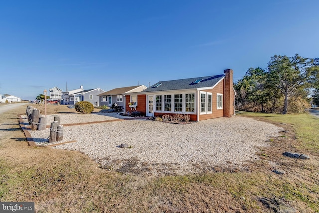 rear view of property featuring a yard