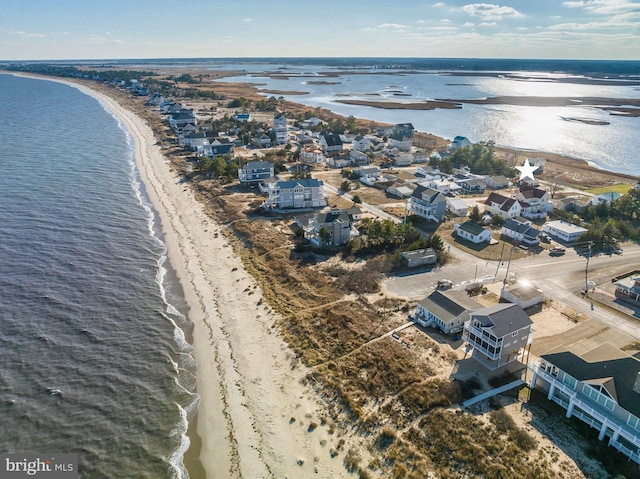 aerial view featuring a view of the beach and a water view