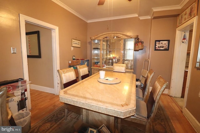 dining room featuring ceiling fan, dark hardwood / wood-style flooring, and crown molding