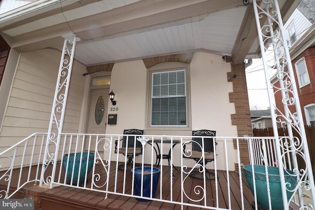 property entrance featuring a swimming pool and covered porch