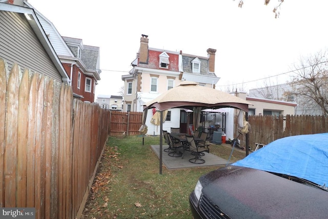 rear view of house with a gazebo and a patio area