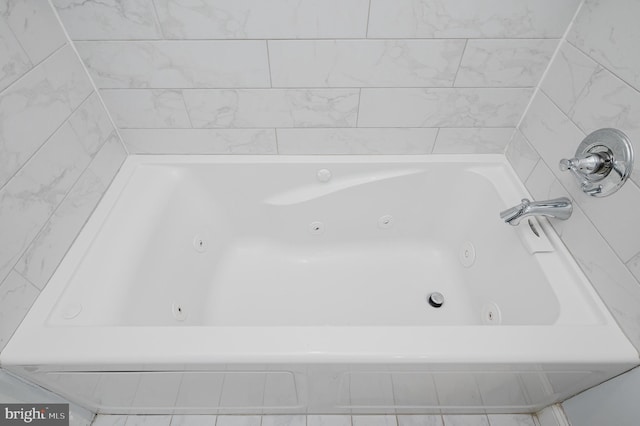 bathroom with a relaxing tiled tub