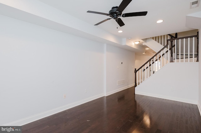 unfurnished living room with ceiling fan and dark wood-type flooring