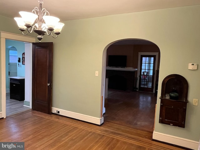 interior space featuring a chandelier and wood-type flooring