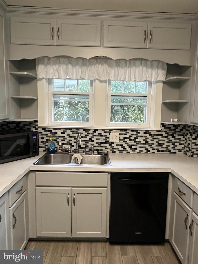 kitchen featuring gray cabinetry, black appliances, sink, decorative backsplash, and light hardwood / wood-style floors