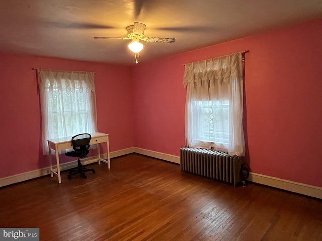 office area with hardwood / wood-style flooring, radiator, and ceiling fan